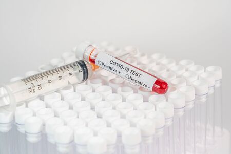 Blood test of COVID-19 and medical syringe on white backgroundの写真素材