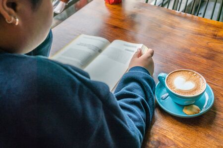 Young woman stay home and reading books in the morningの写真素材