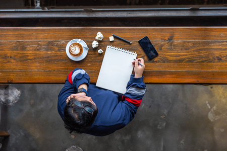 Asian woman stay home and draw on sketchbook