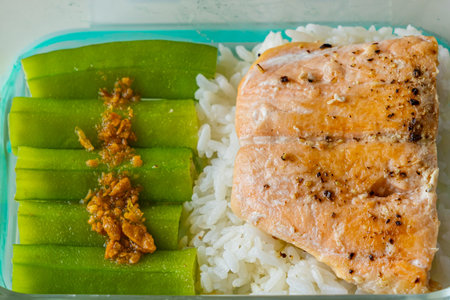 Steamed okra and baked salmon served with white riceの写真素材