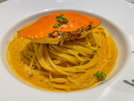 Tasty crab spaghetti served with cheddar cheese sauceの写真素材