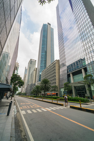 Makati, Philippines - August 2018: Financial office buildings along empty street during lockdown