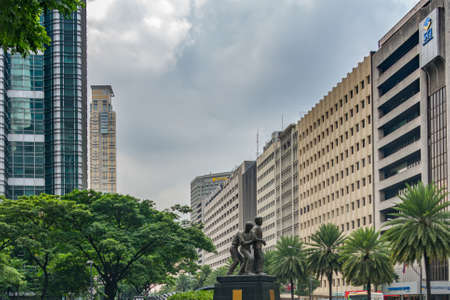 Makati, Metro Manila, Philippines - August 2018: Ninoy Aquino Monument and buildings on Ayala avenueのeditorial素材