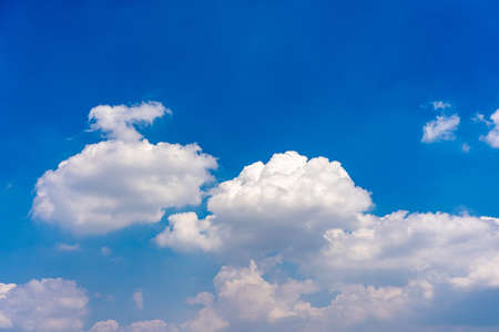 Cotton like white clouds on blue sky backgroundの写真素材