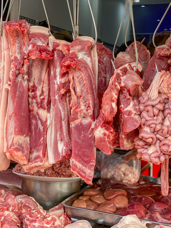 Pile of raw red meat hang at local market in Vietnamの写真素材
