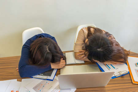 Exhausted office employee working under high pressureの写真素材
