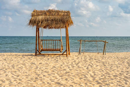 The wooden swing on the beautiful summer beachの写真素材