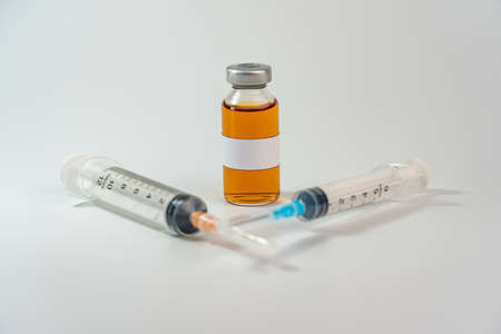 Studio shot of vaccine bottle with blank label and syringesの写真素材