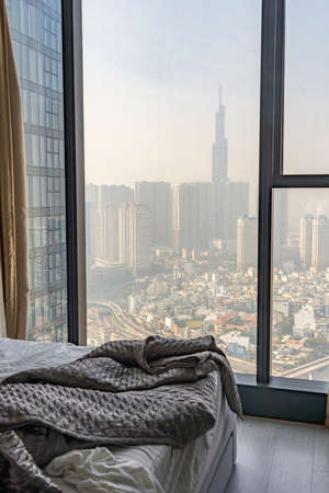 Cityscape view with hazy air polluted sky from bedroomの写真素材