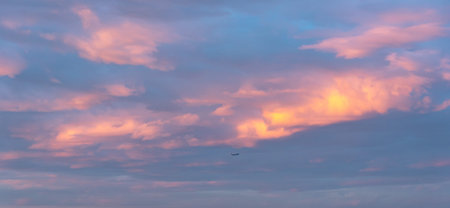 Glowing pink clouds on dramatic sky at sunset
