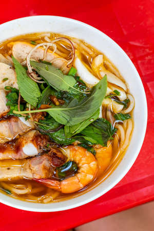Vertical photo of delicious Vietnamese fish stock noodle soup, Bun Mamの写真素材