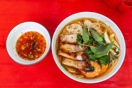 Bowl of Vietnamese seafood and roasted pork noodle, Bun Mamの写真素材