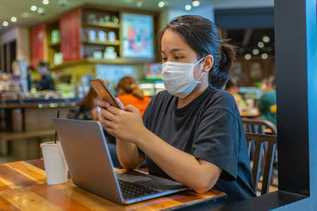 Woman wearing protective mask to prevent Covid-19 infectionの写真素材