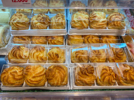 Choux pastry filled with creamy custard for sale at bakeryの写真素材