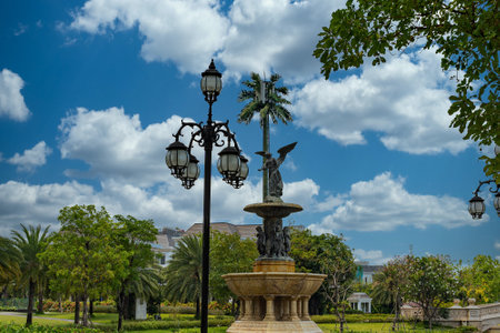 Beautiful morning sky in a park with vintage statue in centerの写真素材