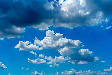 Blue sky background with many white clouds floatingの写真素材