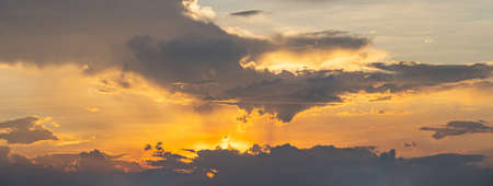 Dramatic sky with orange sunlight at the sunsetの写真素材