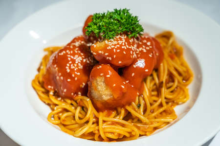 Spaghetti fried chicken cubes with tomato sauceの写真素材