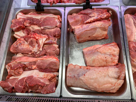 Raw pork meat for sale at butcher stall in supermarketの写真素材