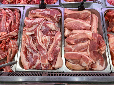 Raw pork meat for sale at butcher stall in supermarketの写真素材