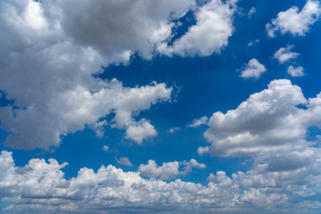 Beautiful blue sky background with white cloudsの写真素材