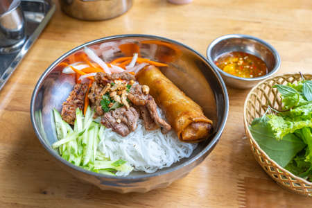 Famous Vietnam food with rice noodles, grill pork and vegetableの写真素材