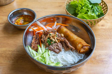 Famous Vietnam food with rice noodles, grill pork and vegetableの写真素材
