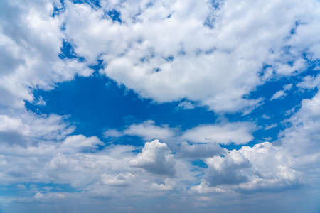 White cumulus clouds on the blue sky backgroundの写真素材