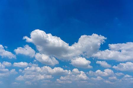 White cumulus clouds on the blue sky backgroundの写真素材