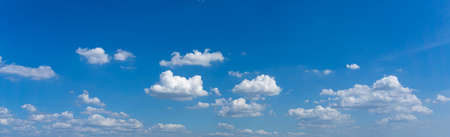 Panoramic photo of blue sky background with white clouds floatingの写真素材