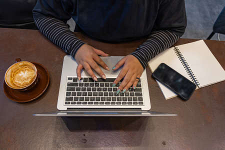 High angle view photo of woman hands typing laptopの写真素材