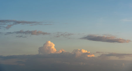 Sunset blue sky background with clouds floatingの写真素材