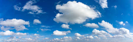 Panorama photo of blue sky background with many floating white cloudsの写真素材