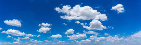 Panorama photo of blue sky background with white cloudsの写真素材