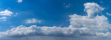 Panoramic photo of blue sky background with white cloudsの写真素材