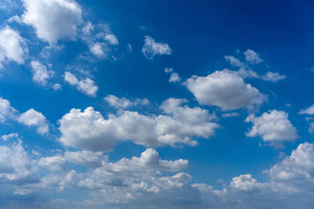 White cumulus cloudy floating in the blue skyの写真素材