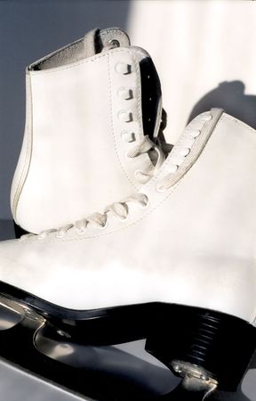 Pair of white ice skates for figure-skatingの写真素材