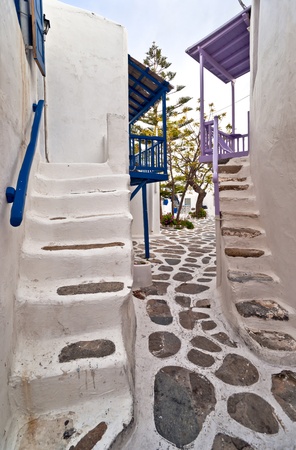 Mykonos street with external stairs of the houses and colourful balconiesの写真素材