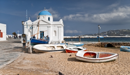 Mykonos city beach out of season with fishboatsのeditorial素材