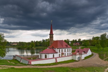 Earthen Prioratsky palace with red roof in Gatchina, Russiaのeditorial素材