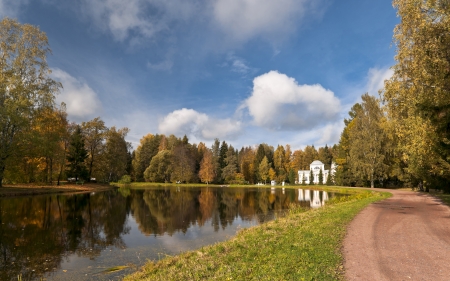 Classical white pavilion next to water with fall trees reflectionのeditorial素材