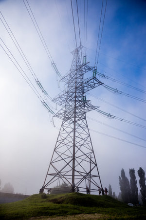 Power line with wires in the morning fog