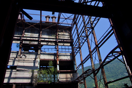 Abandoned, destroyed by war and overgrown machinery of Tkvarcheli power plant, Abkhazia, Georgiaの写真素材