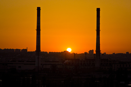 Sunset between two pipes of power plant at Voronezh industrial areaの写真素材