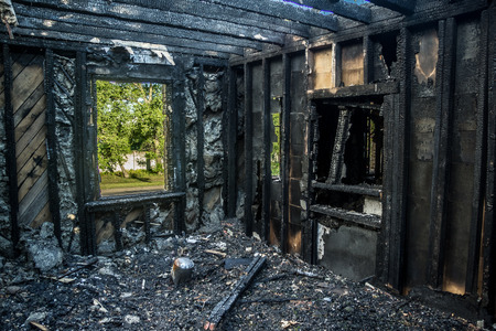 Interior of a burnt by fire apartment in an apartment building. Burned wooden beamsの写真素材