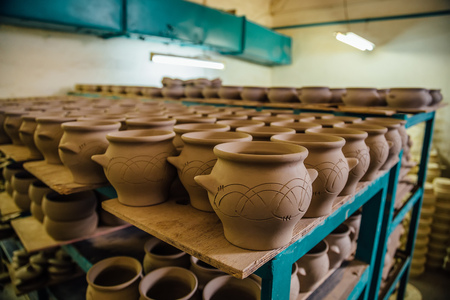 Pottery workshop. Drying unbaked pottery after molding.の写真素材