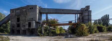 Panorama of territory of abandoned factory of reinforced concrete.の写真素材