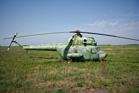 Abandoned Russian military helicopter on the fieldの写真素材