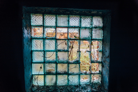 View through the broken glass block window.の写真素材