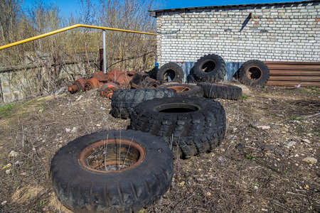 Abandoned rotten tires and vehicle wheels in the junk.の写真素材